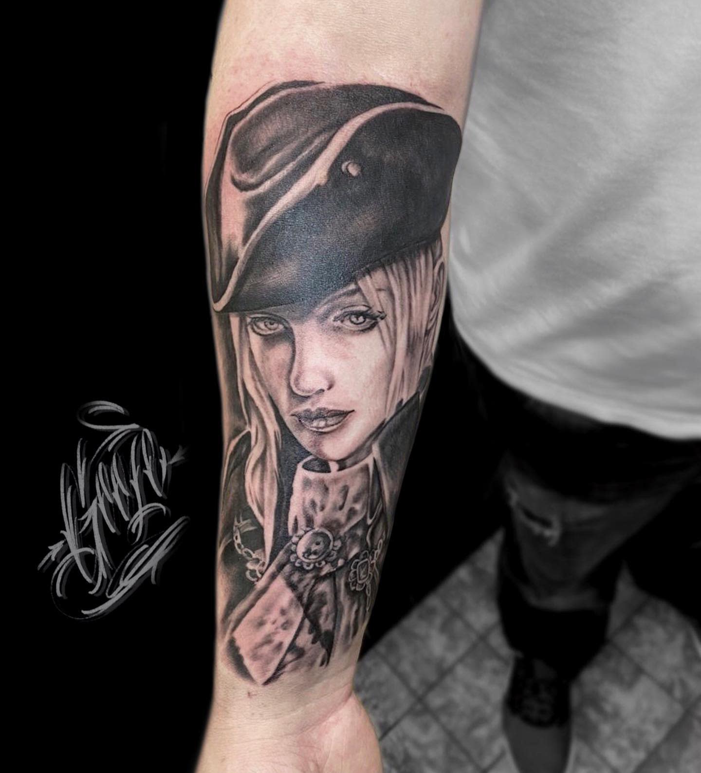 Realistic forearm tattoo of Lady Maria from Bloodborne, with detailed shading and expressive eyes